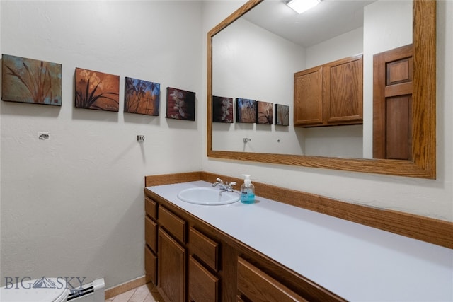 bathroom with tile patterned floors, vanity, and baseboard heating