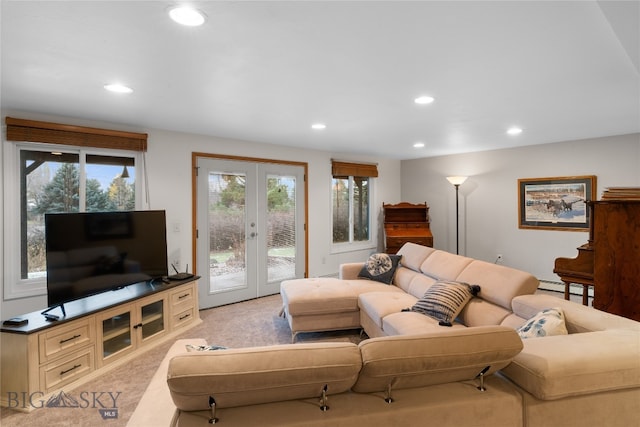 carpeted living room featuring a baseboard radiator, a wealth of natural light, and french doors