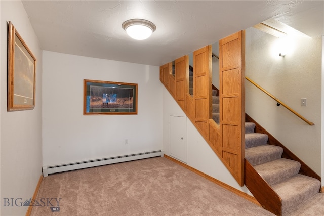 interior space with light colored carpet and baseboard heating