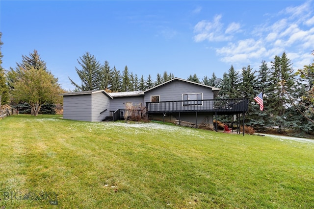 rear view of property with a yard and a deck