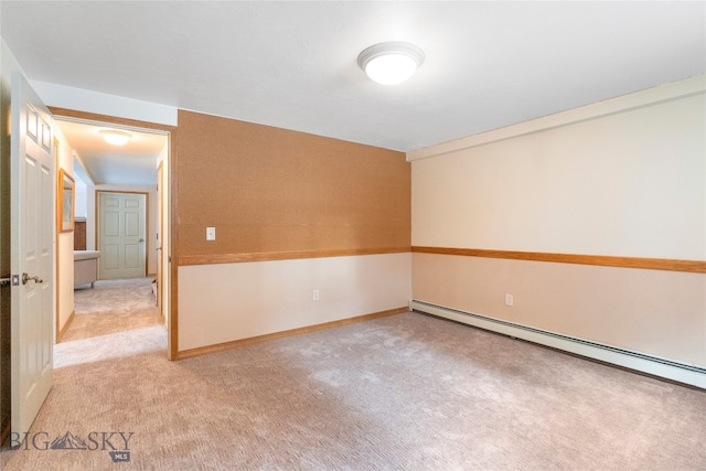 unfurnished room featuring baseboard heating and light carpet