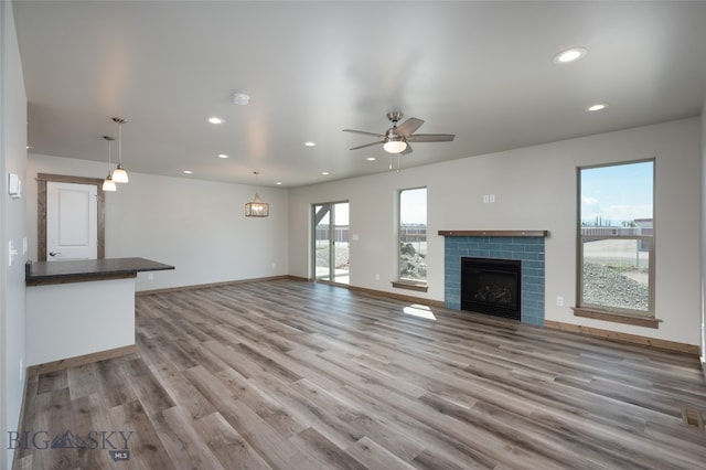 unfurnished living room with ceiling fan and light hardwood / wood-style floors