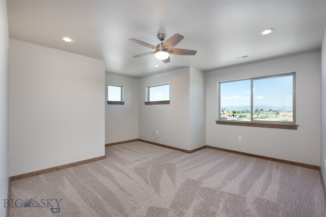 unfurnished room with light carpet and ceiling fan