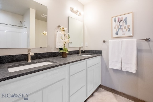 bathroom featuring vanity and a shower