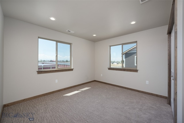 unfurnished bedroom with multiple windows and light carpet