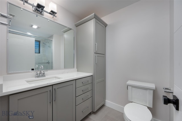 bathroom featuring tile patterned floors, vanity, an enclosed shower, and toilet