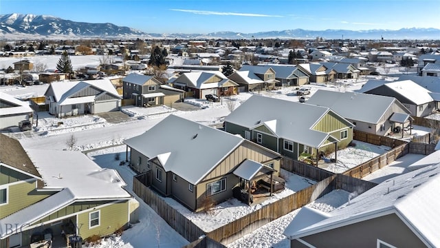 snowy aerial view featuring a mountain view