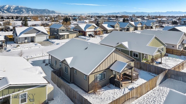 snowy aerial view with a mountain view