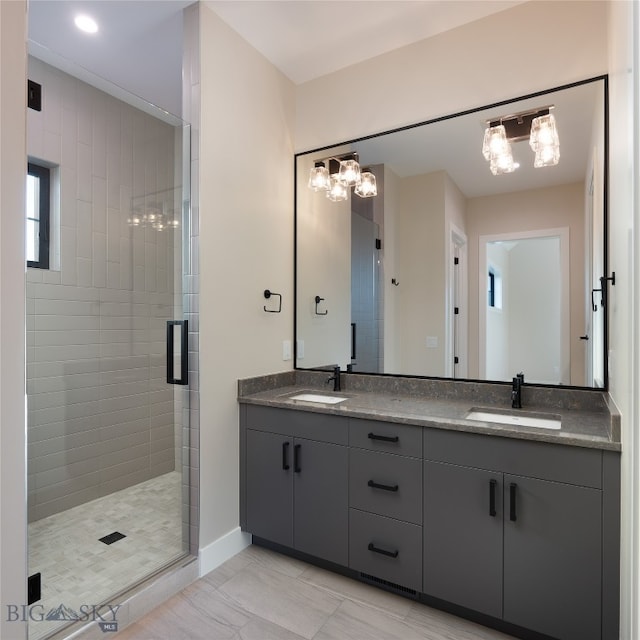 bathroom featuring vanity, a shower with shower door, and a wealth of natural light