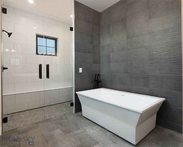 bathroom with plus walk in shower and tile walls