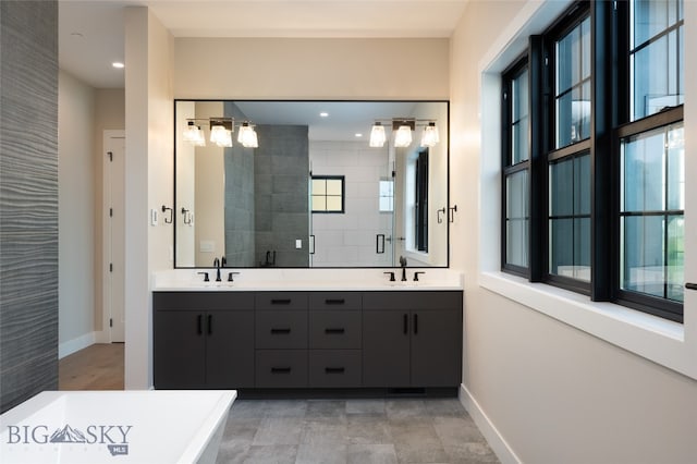 bathroom featuring a shower with door and vanity