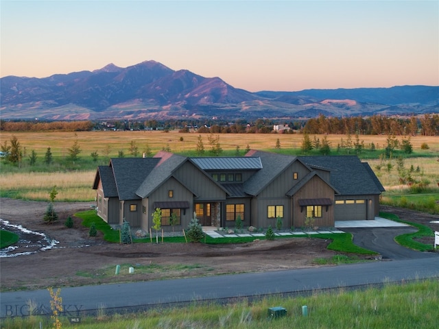 view of front facade featuring a mountain view and a garage