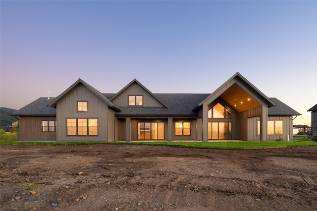 view of back house at dusk