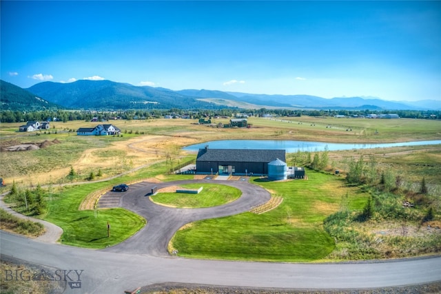 birds eye view of property with a rural view and a water and mountain view