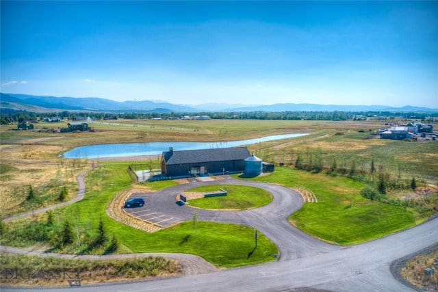 drone / aerial view featuring a water and mountain view