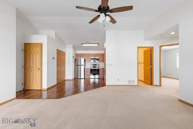 unfurnished living room featuring ceiling fan, light hardwood / wood-style flooring, and vaulted ceiling