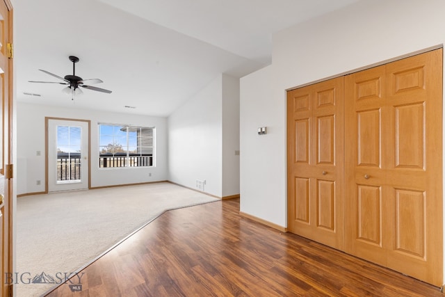 spare room with dark hardwood / wood-style flooring, ceiling fan, and lofted ceiling