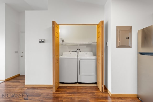 laundry room with washer and clothes dryer, dark hardwood / wood-style flooring, and electric panel