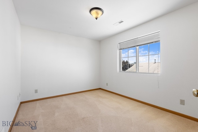 spare room with light colored carpet