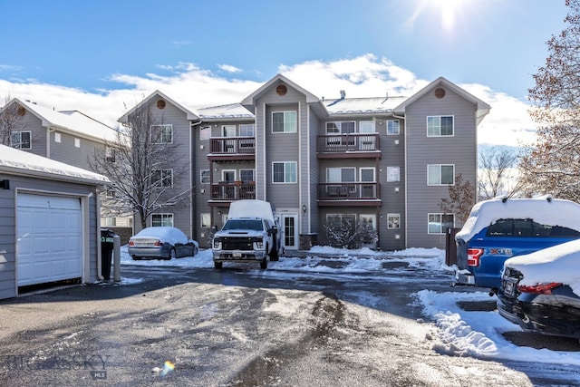 snow covered property featuring a garage