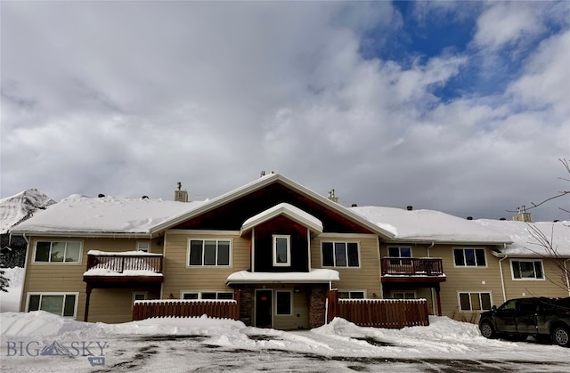 view of snow covered rear of property