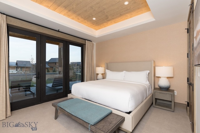 bedroom with access to exterior, french doors, wooden ceiling, a tray ceiling, and light carpet