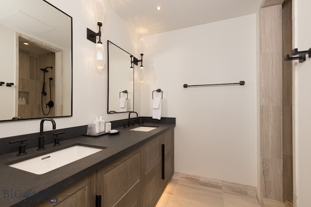 bathroom featuring a shower and vanity