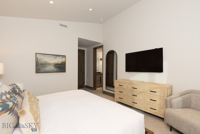 bedroom featuring carpet and vaulted ceiling