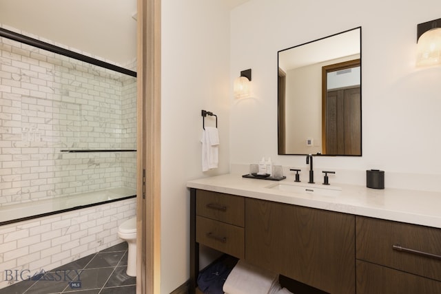 full bathroom featuring tile patterned flooring, vanity, toilet, and enclosed tub / shower combo