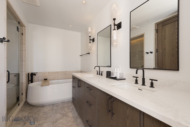 bathroom featuring tile patterned flooring, vanity, and separate shower and tub