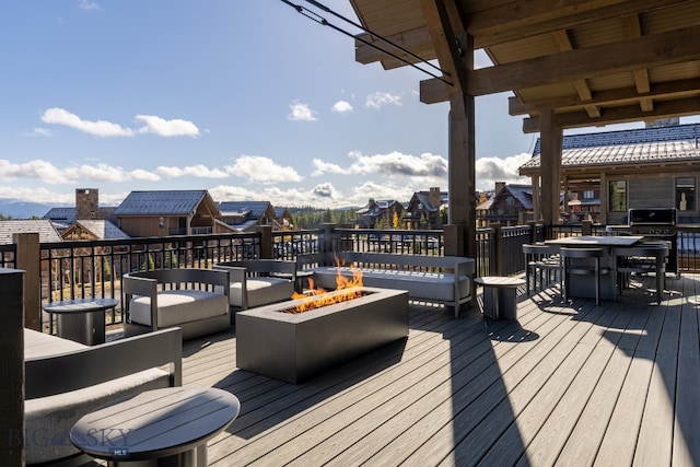 wooden deck featuring an outdoor fire pit