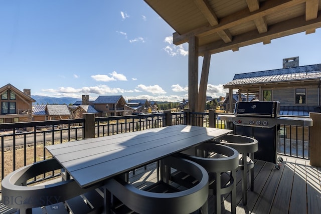 wooden deck featuring a grill