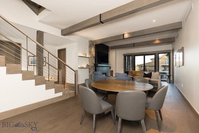117 Martingale Frk Unit 6, Big Sky, MT 59716 - dining area with wood finished floors, beam ceiling, stairway, and baseboards