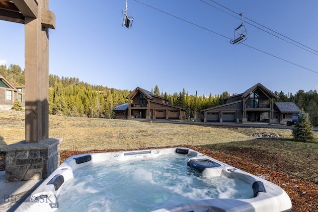 view of yard featuring a garage and a hot tub