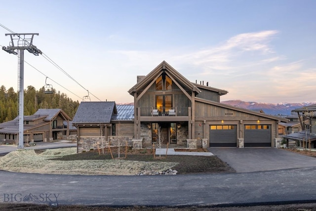 117 Martingale Frk Unit 6, Big Sky, MT 59716 - view of front of home featuring stone siding, asphalt driveway, a balcony, and an attached garage