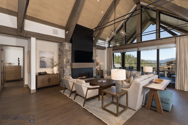 living room with a fireplace, high vaulted ceiling, dark wood-type flooring, and an inviting chandelier