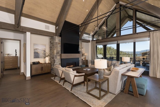 117 Martingale Frk Unit 6, Big Sky, MT 59716 - living room with a large fireplace, high vaulted ceiling, beamed ceiling, dark wood-type flooring, and baseboards