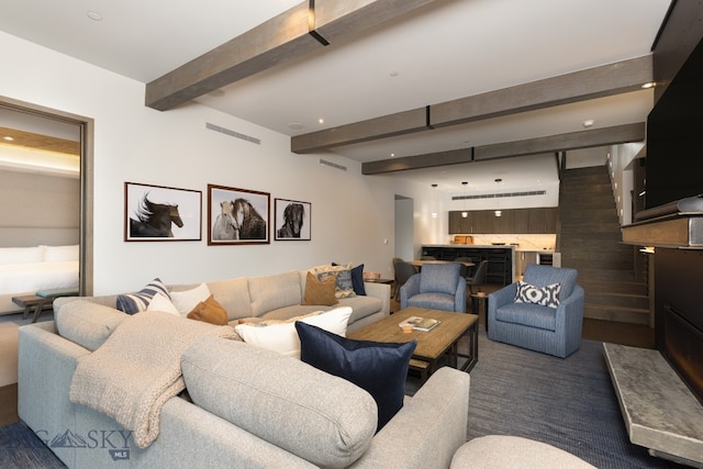 living room featuring beamed ceiling