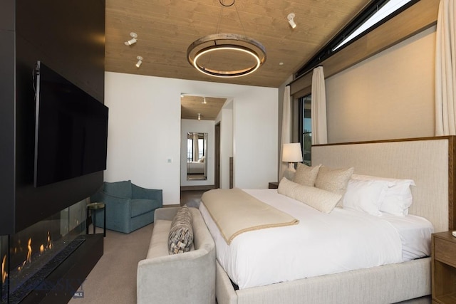 117 Martingale Frk Unit 6, Big Sky, MT 59716 - carpeted bedroom with wooden ceiling and a lit fireplace