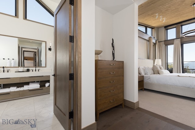 bedroom with sink, high vaulted ceiling, light hardwood / wood-style flooring, and wood ceiling