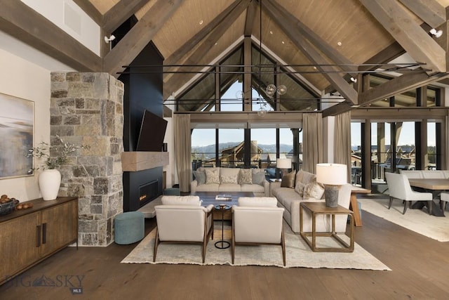 117 Martingale Frk Unit 6, Big Sky, MT 59716 - living area featuring high vaulted ceiling, a fireplace, wood finished floors, and wood ceiling with exposed beams