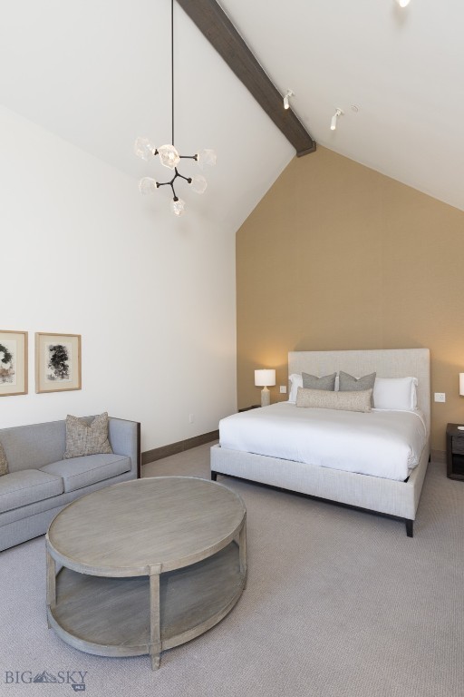 carpeted bedroom with beamed ceiling and high vaulted ceiling