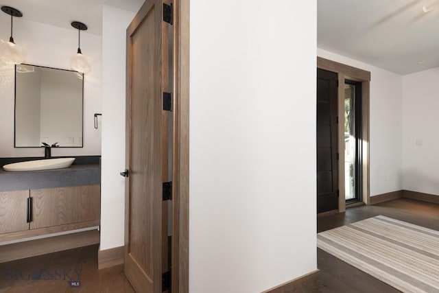 117 Martingale Frk Unit 6, Big Sky, MT 59716 - hall featuring a sink, wood finished floors, and baseboards