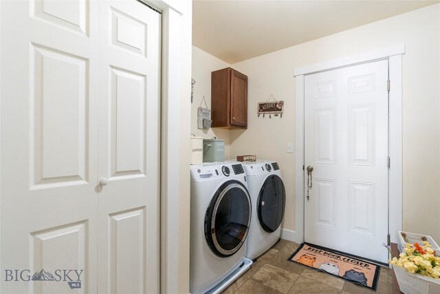 laundry area featuring cabinets, separate washer and dryer, and light tile patterned floors