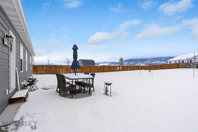 snowy yard with a mountain view