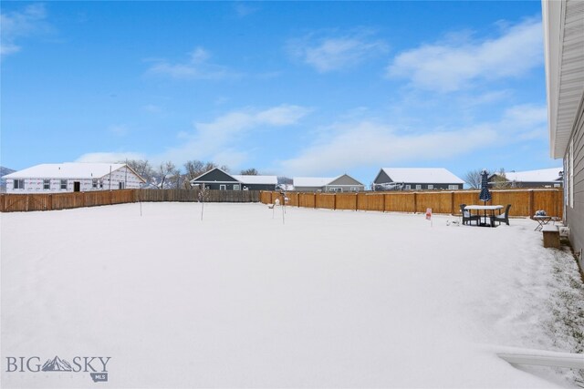 view of yard layered in snow