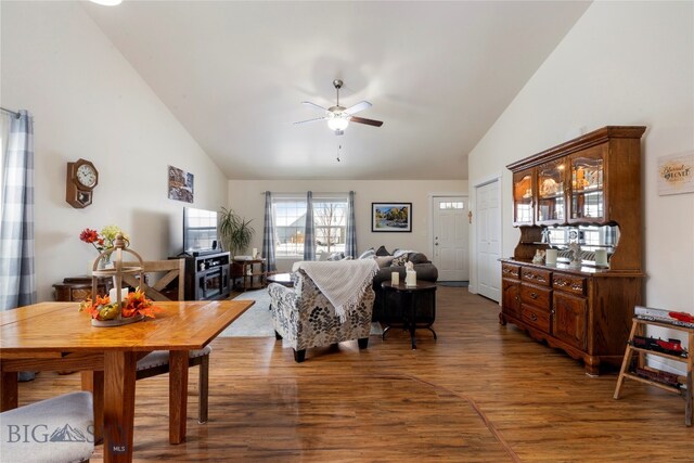 living room with hardwood / wood-style flooring, high vaulted ceiling, and ceiling fan