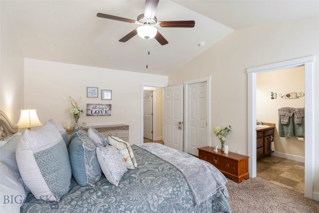 bedroom with carpet, connected bathroom, ceiling fan, and lofted ceiling