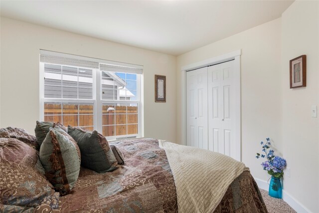 carpeted bedroom featuring a closet