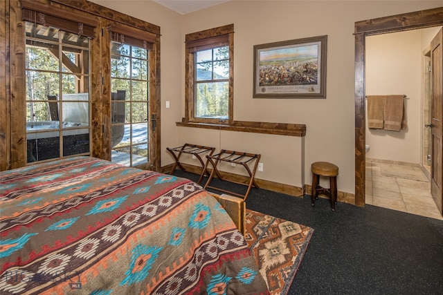 tiled bedroom featuring access to exterior and multiple windows